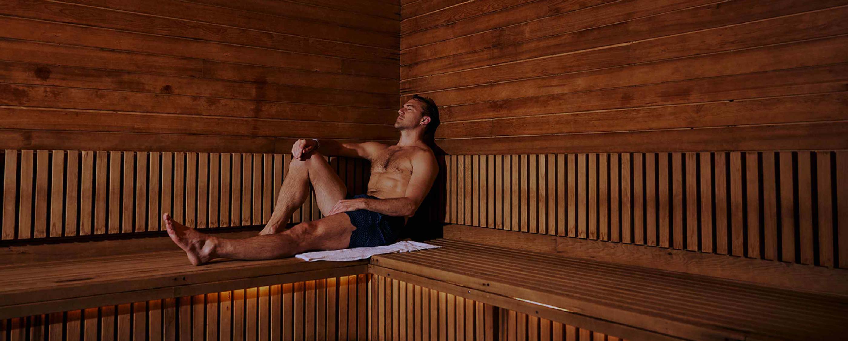 a neatly folded towel on a bench in an all-wood sauna