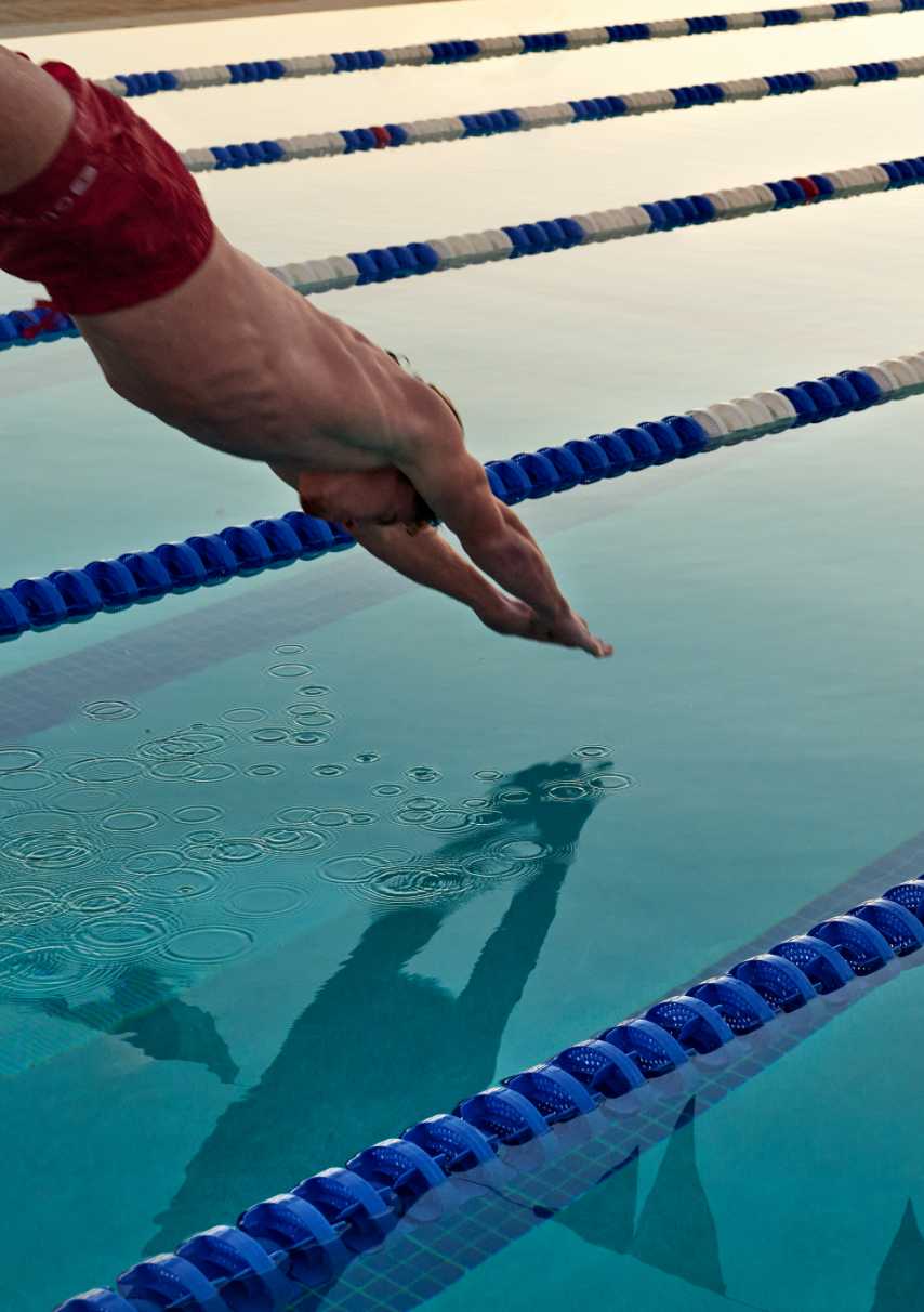 A man diving into the pool at Life Time