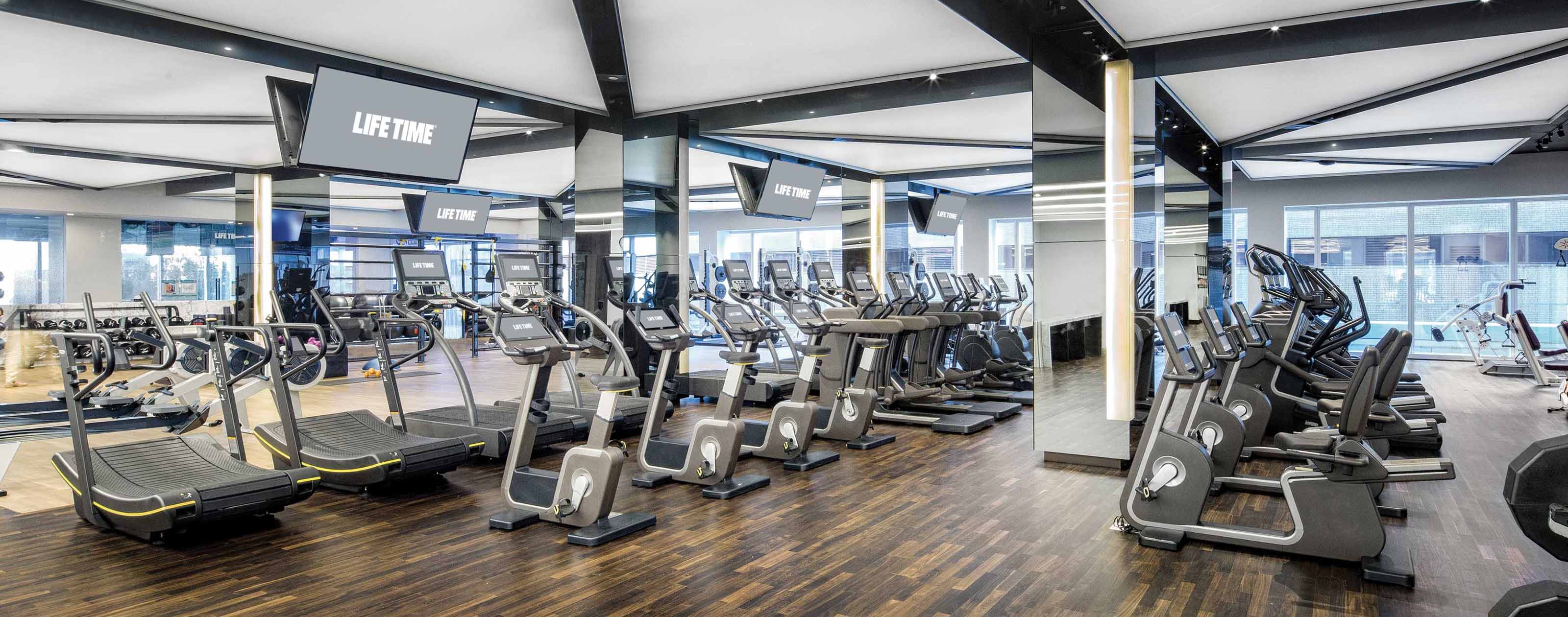 rows of cardio machines and TVs
