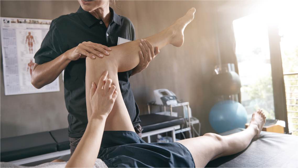 Physical Therapist helping a member stretch