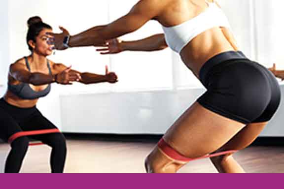 A man and woman curling barbells
