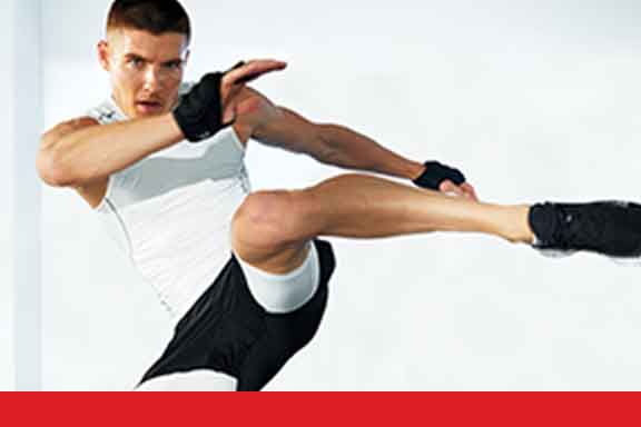 A man poised to kick his left leg
